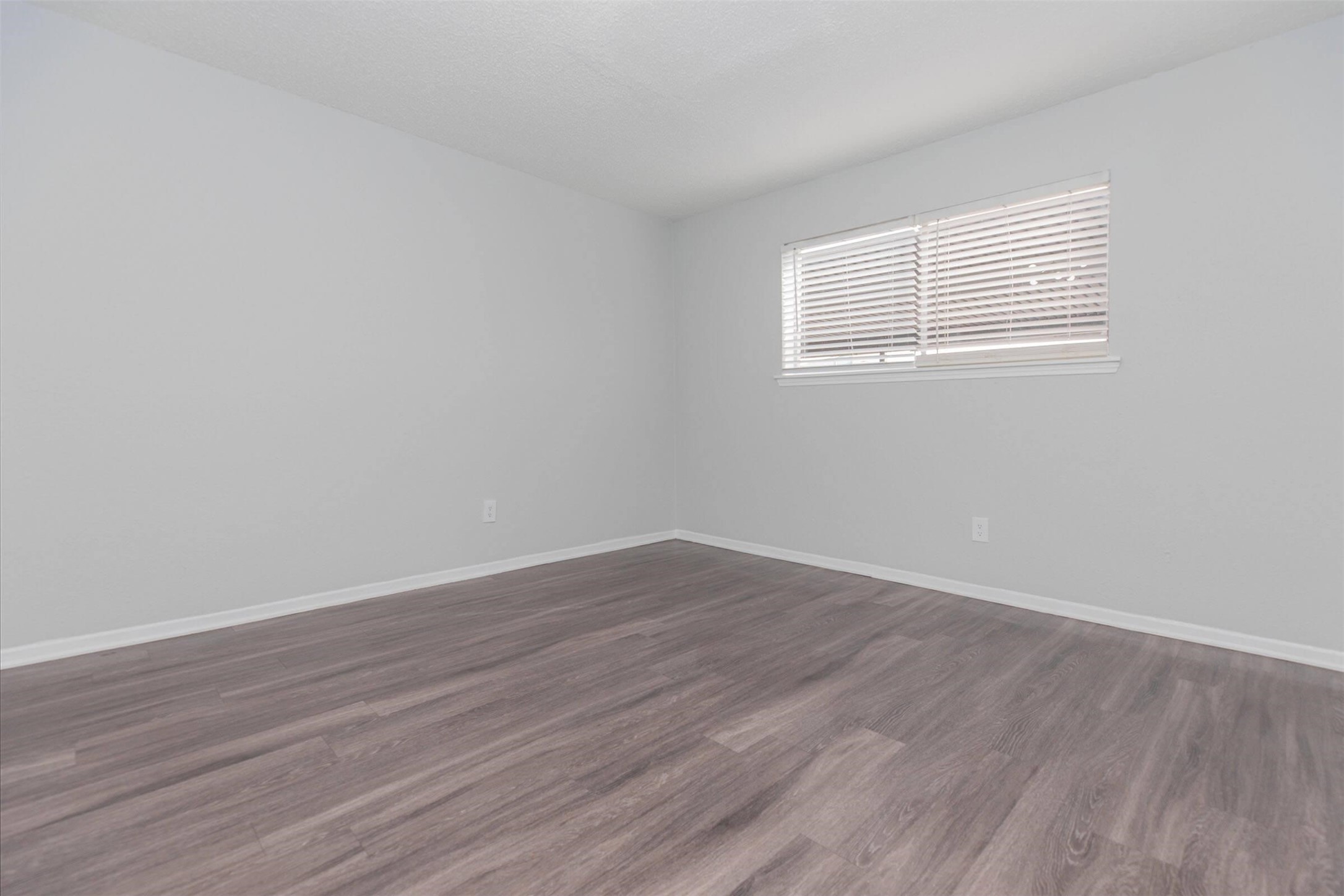 3001 Hillcroft Street, Unit G0605 Houston, TX 77057 - Photo 14 of 50 a view of an empty room with wooden floor and a window