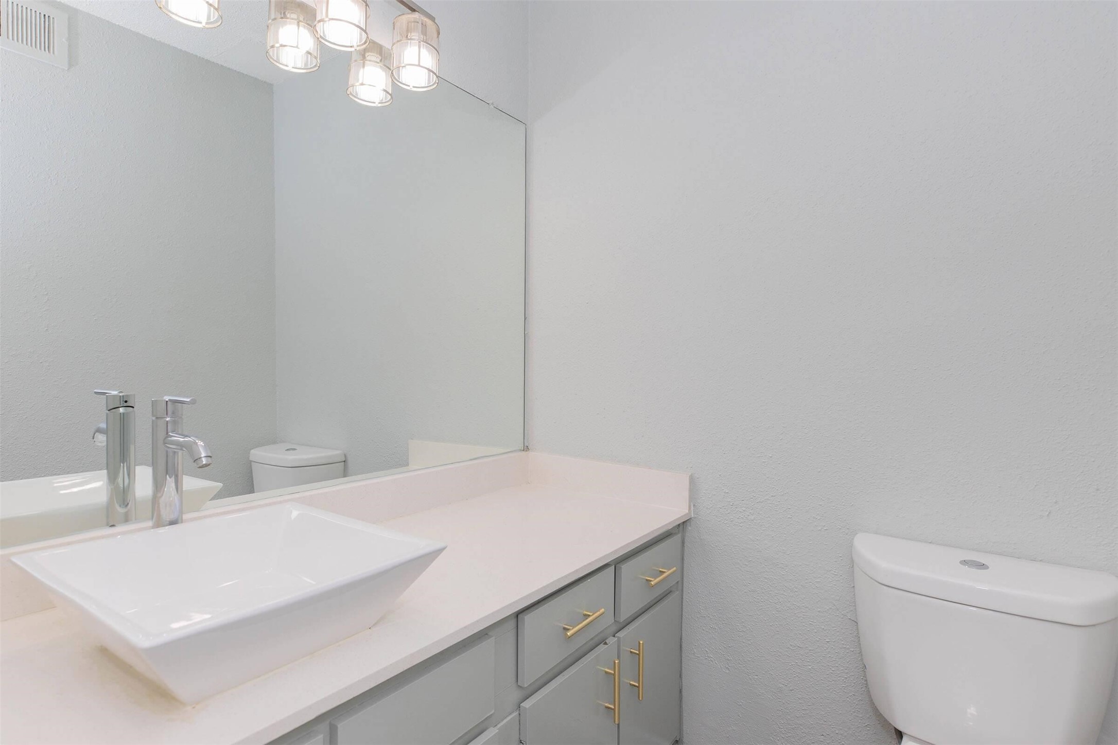 3001 Hillcroft Street, Unit G0605 Houston, TX 77057 - Photo 16 of 50 a bathroom with a sink a toilet and a mirror