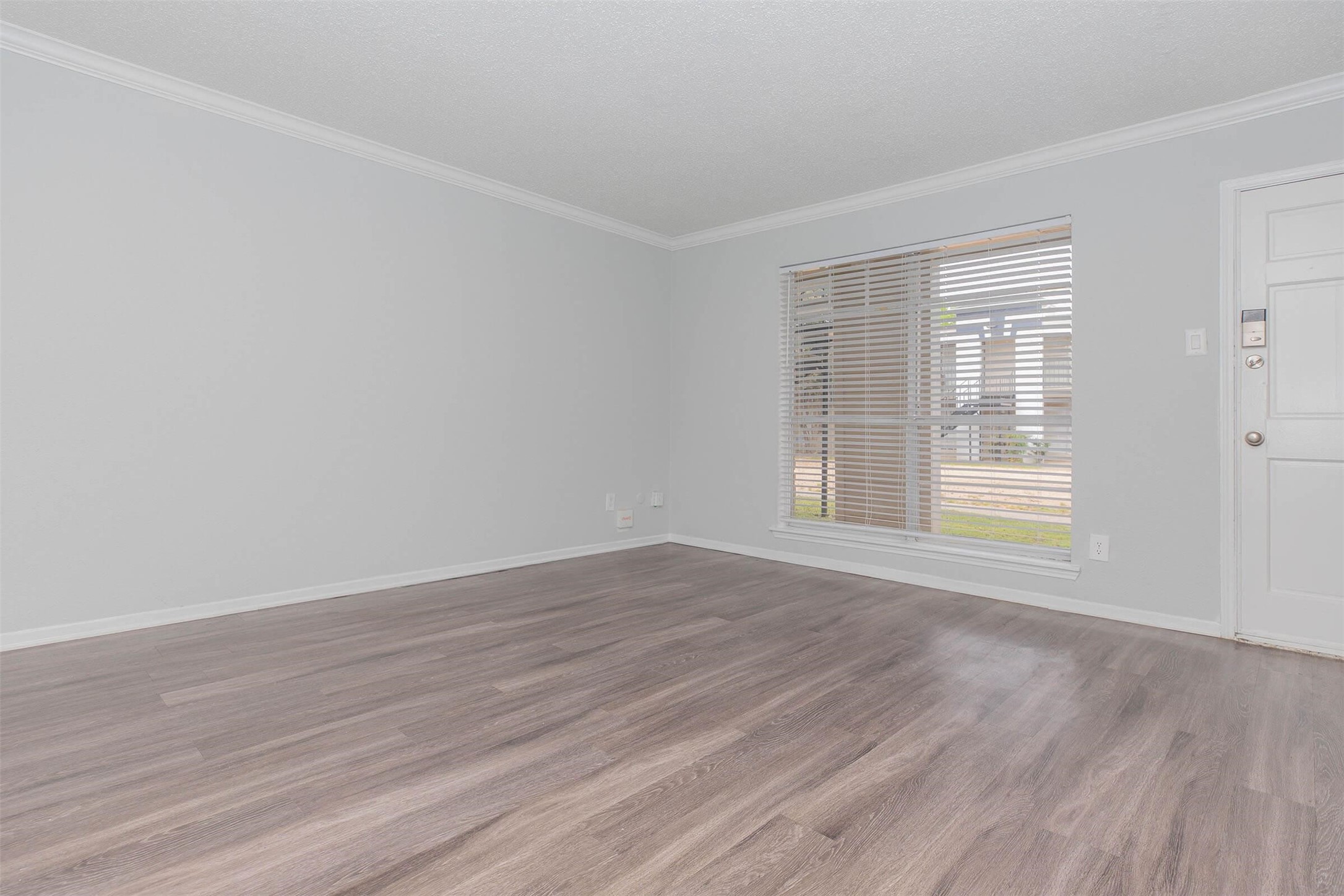 3001 Hillcroft Street, Unit G0605 Houston, TX 77057 - Photo 8 of 50 a view of an empty room with wooden floor and a window
