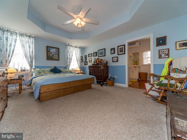 3129 Fairfield Road Gettysburg, PA 17325 - Photo 41 of 47 a bedroom with a bed and a chandelier