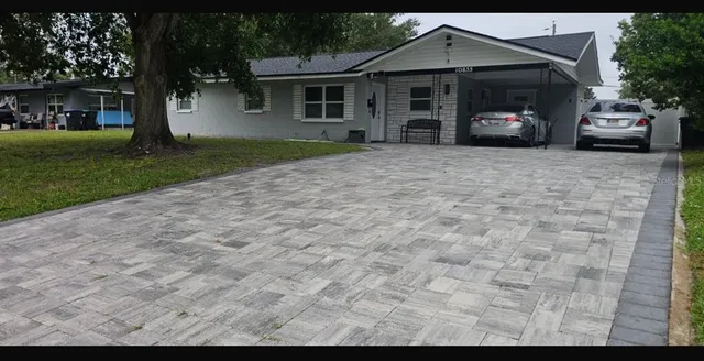a view of a house with a garden and pathway
