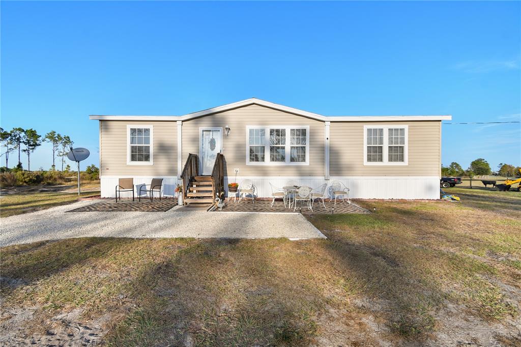 10989 Northwest Lily County Line Road Ona, FL 33865 - Photo 26 of 87 a front view of a house with a yard