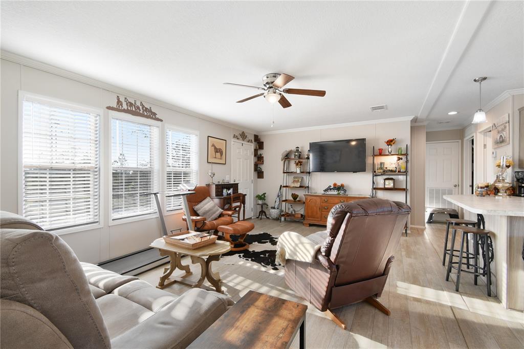 10989 Northwest Lily County Line Road Ona, FL 33865 - Photo 31 of 87 a living room with furniture and a flat screen tv