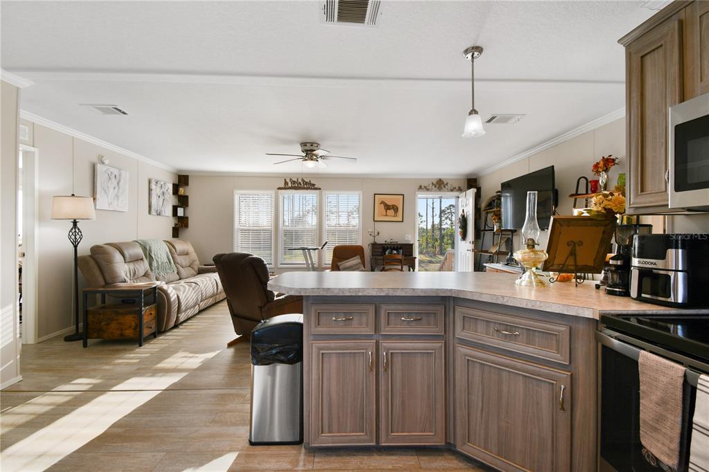 10989 Northwest Lily County Line Road Ona, FL 33865 - Photo 38 of 87 a kitchen with cabinets and chairs