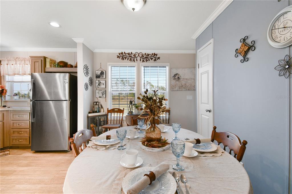 10989 Northwest Lily County Line Road Ona, FL 33865 - Photo 46 of 87 a kitchen with stainless steel appliances granite countertop a refrigerator and a dining table