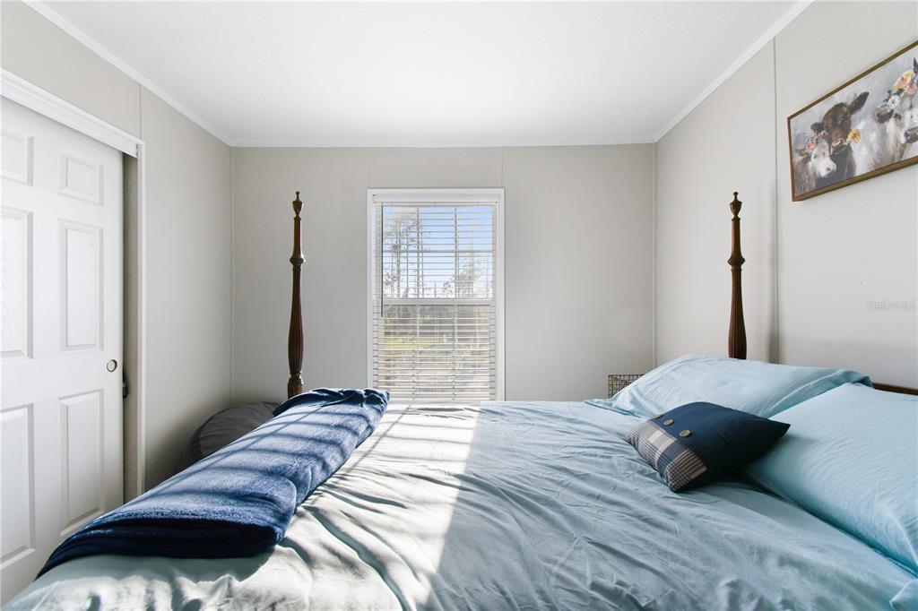 10989 Northwest Lily County Line Road Ona, FL 33865 - Photo 59 of 87 a bedroom with a bed and a window