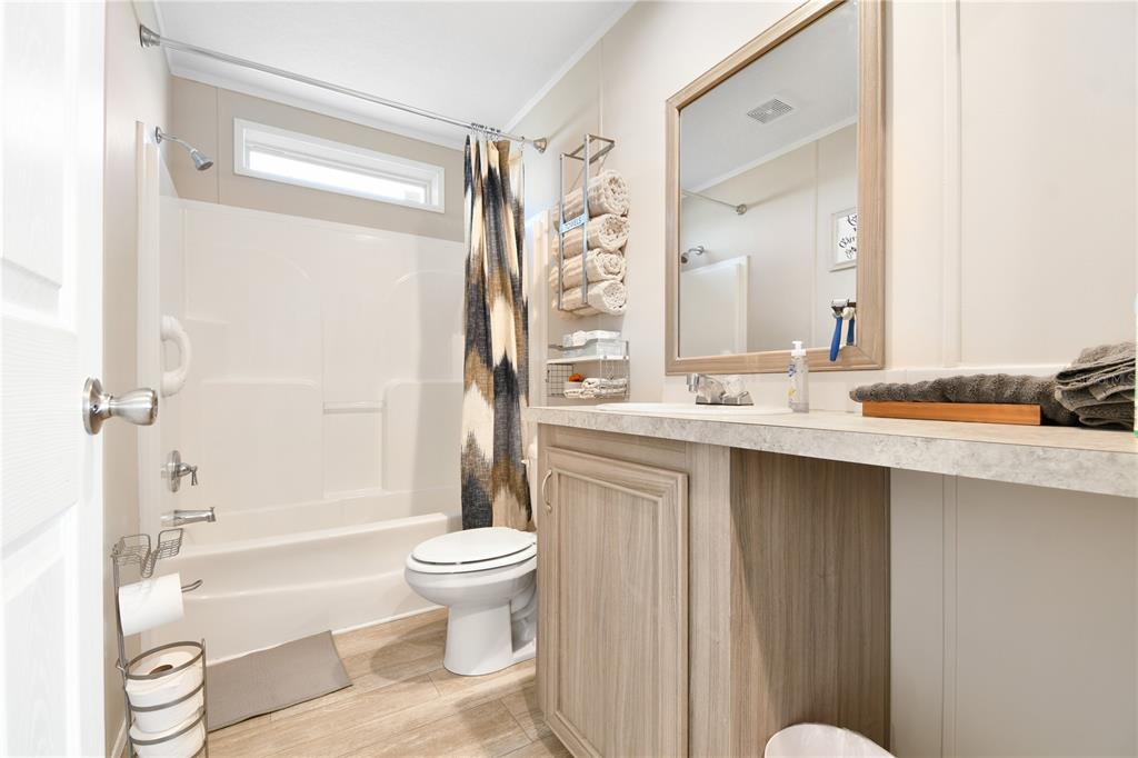 10989 Northwest Lily County Line Road Ona, FL 33865 - Photo 63 of 87 a bathroom with a granite countertop sink toilet a shower and a bathtub