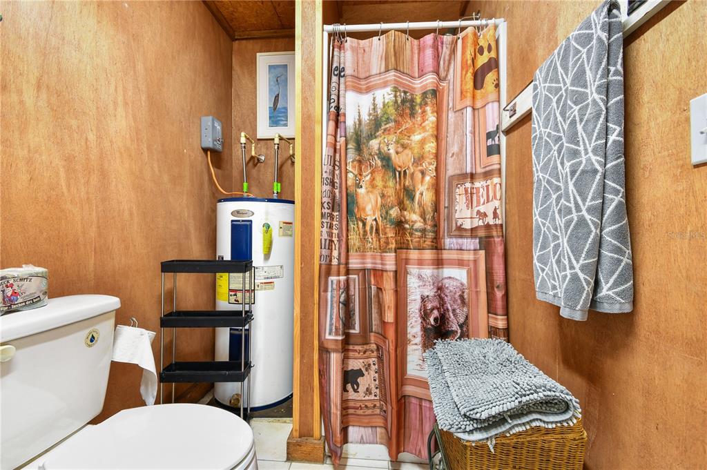 10989 Northwest Lily County Line Road Ona, FL 33865 - Photo 76 of 87 a bathroom with a granite countertop toilet and a shower curtain