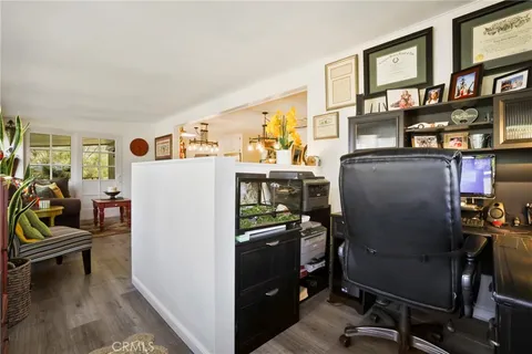 a view of a workspace with furniture and a refrigerator