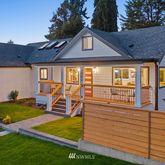 a view of a house with backyard and sitting area