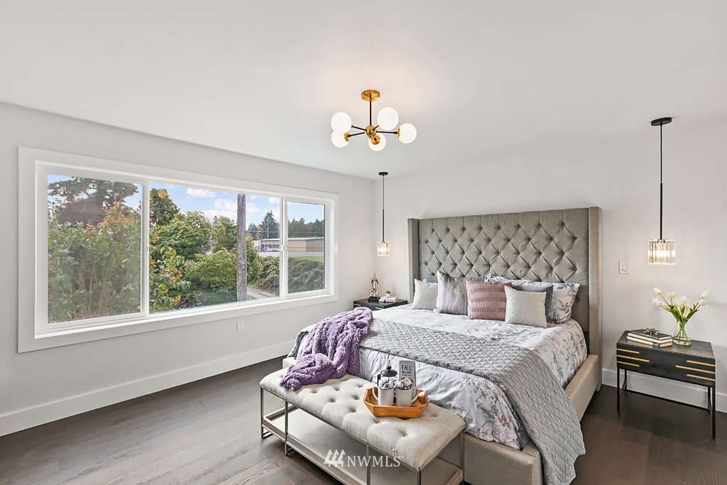 4906 Southwest Hinds Street Seattle, WA 98116 - Photo 13 of 40 a bedroom with a large bed and a window