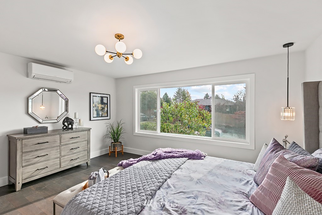 4906 Southwest Hinds Street Seattle, WA 98116 - Photo 14 of 40 a bedroom with a large bed and a window
