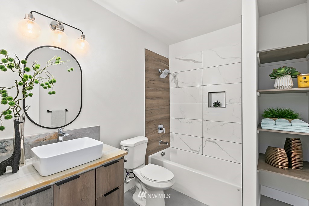 4906 Southwest Hinds Street Seattle, WA 98116 - Photo 15 of 40 a bathroom with a toilet sink and shower