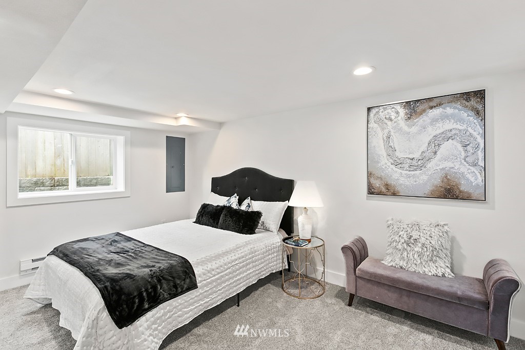 4906 Southwest Hinds Street Seattle, WA 98116 - Photo 17 of 40 a bedroom with a bed and a couch