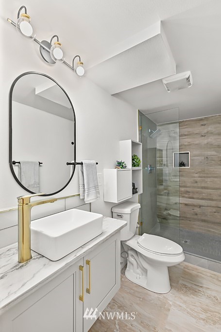 4906 Southwest Hinds Street Seattle, WA 98116 - Photo 19 of 40 a bathroom with a sink a toilet and a mirror