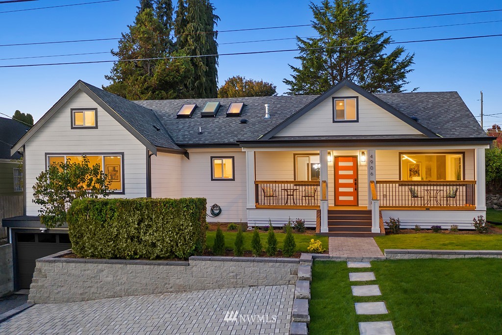 4906 Southwest Hinds Street Seattle, WA 98116 - Photo 3 of 40 a front view of a house with a yard