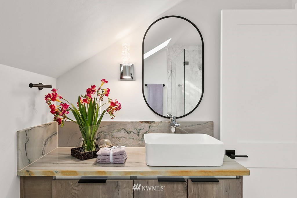 4906 Southwest Hinds Street Seattle, WA 98116 - Photo 21 of 40 a bathroom with a sink and a mirror