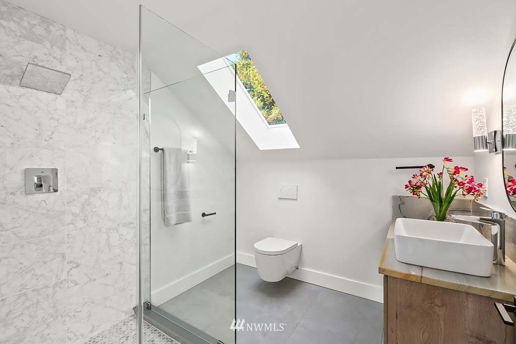 4906 Southwest Hinds Street Seattle, WA 98116 - Photo 22 of 40 a bathroom with a toilet sink and shower