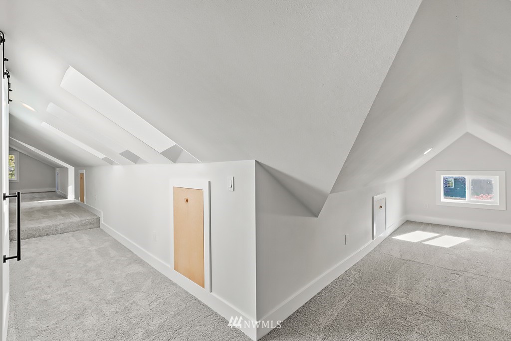 4906 Southwest Hinds Street Seattle, WA 98116 - Photo 23 of 40 a view of a hallway with windows