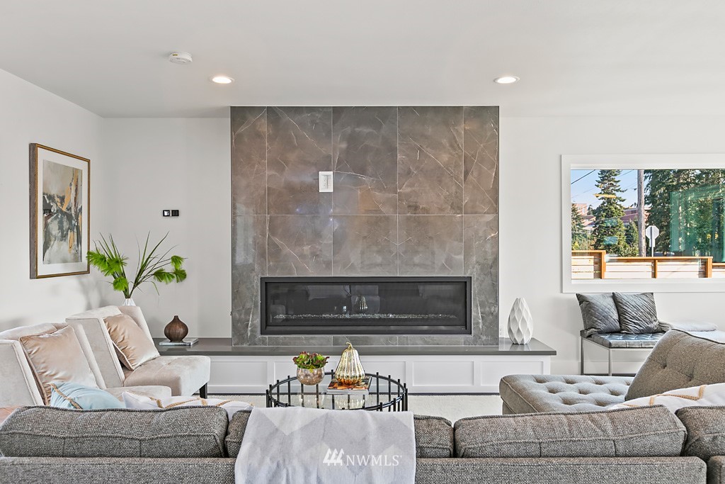 4906 Southwest Hinds Street Seattle, WA 98116 - Photo 34 of 40 a living room with furniture and a fireplace