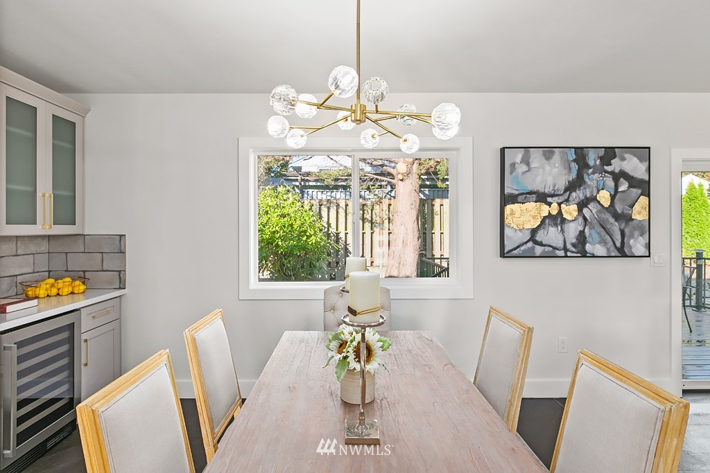 4906 Southwest Hinds Street Seattle, WA 98116 - Photo 36 of 40 a view of a dining room with furniture a chandelier and wooden floor
