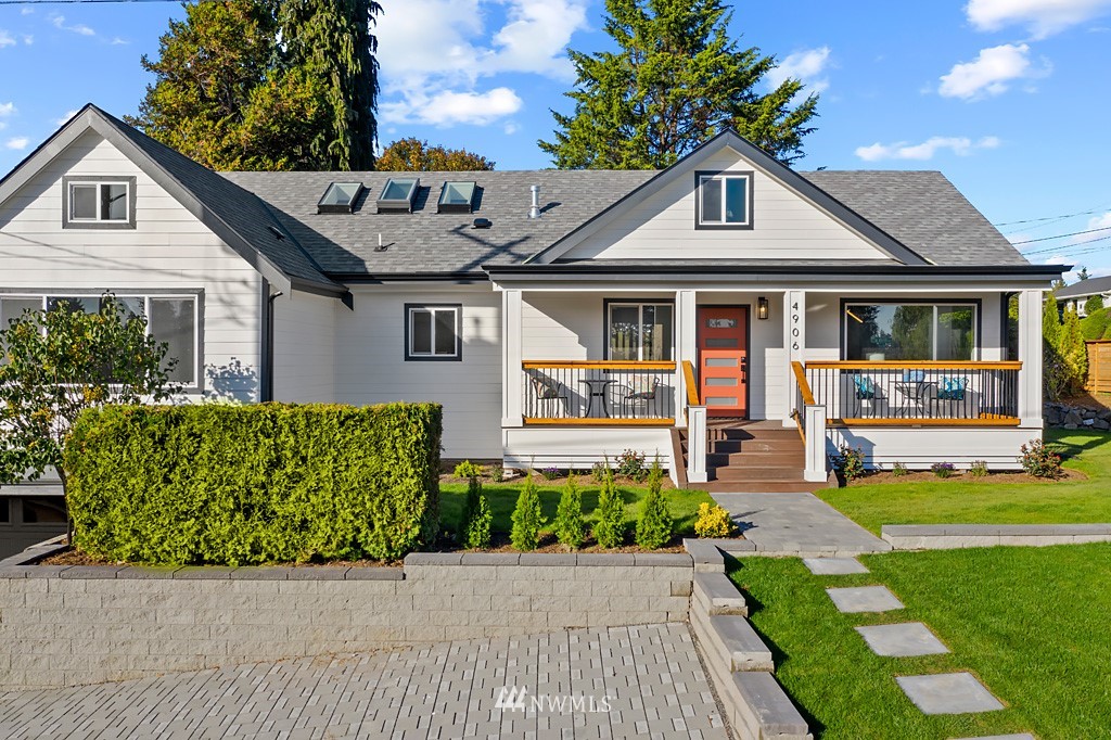 4906 Southwest Hinds Street Seattle, WA 98116 - Photo 5 of 40 a front view of a house with a yard