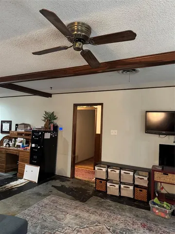a view of a livingroom with furniture and a ceiling fan