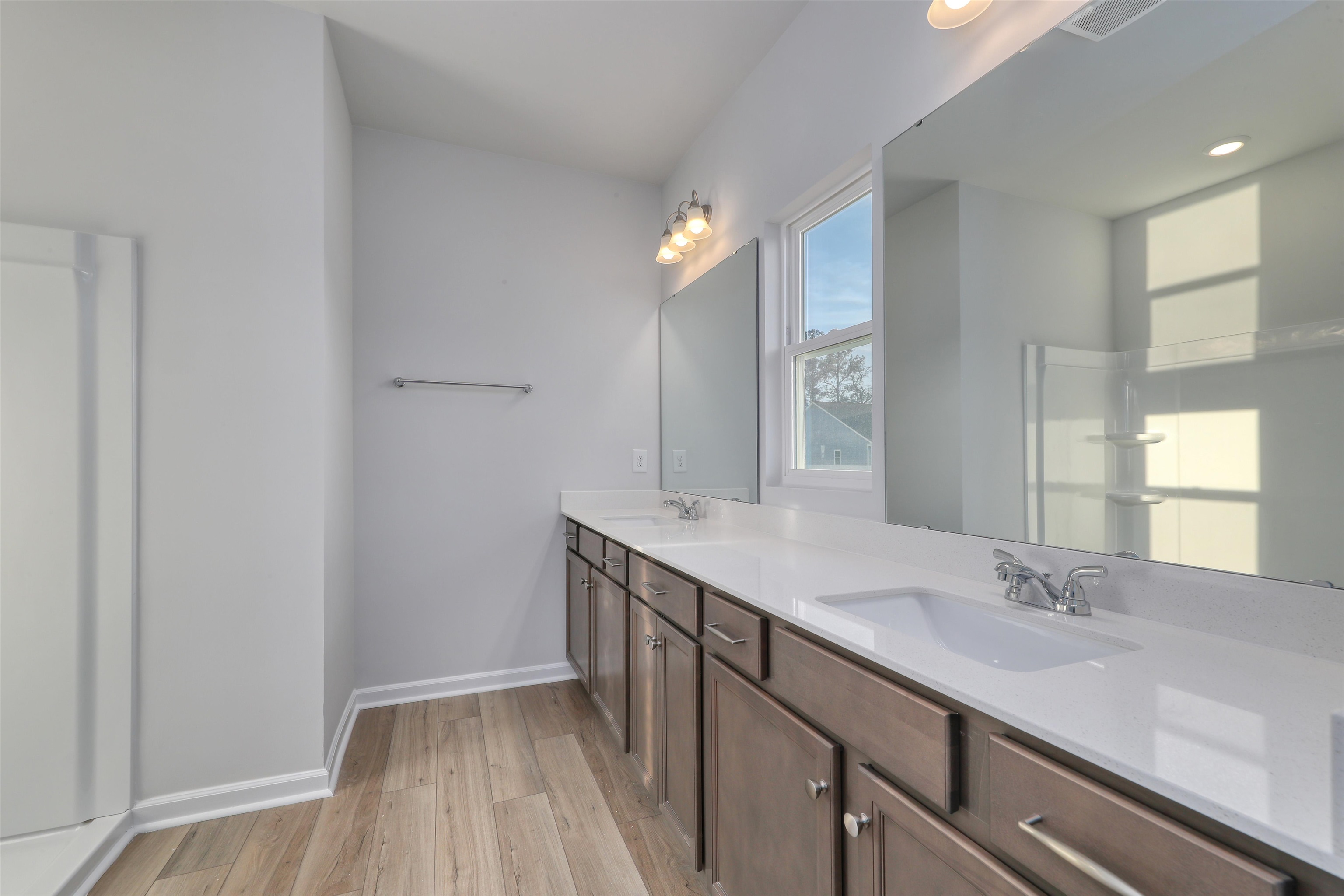 3431 Logan Street Conway, SC 29526 - Photo 22 of 31 Full bath with double vanity and light wood-type flooring