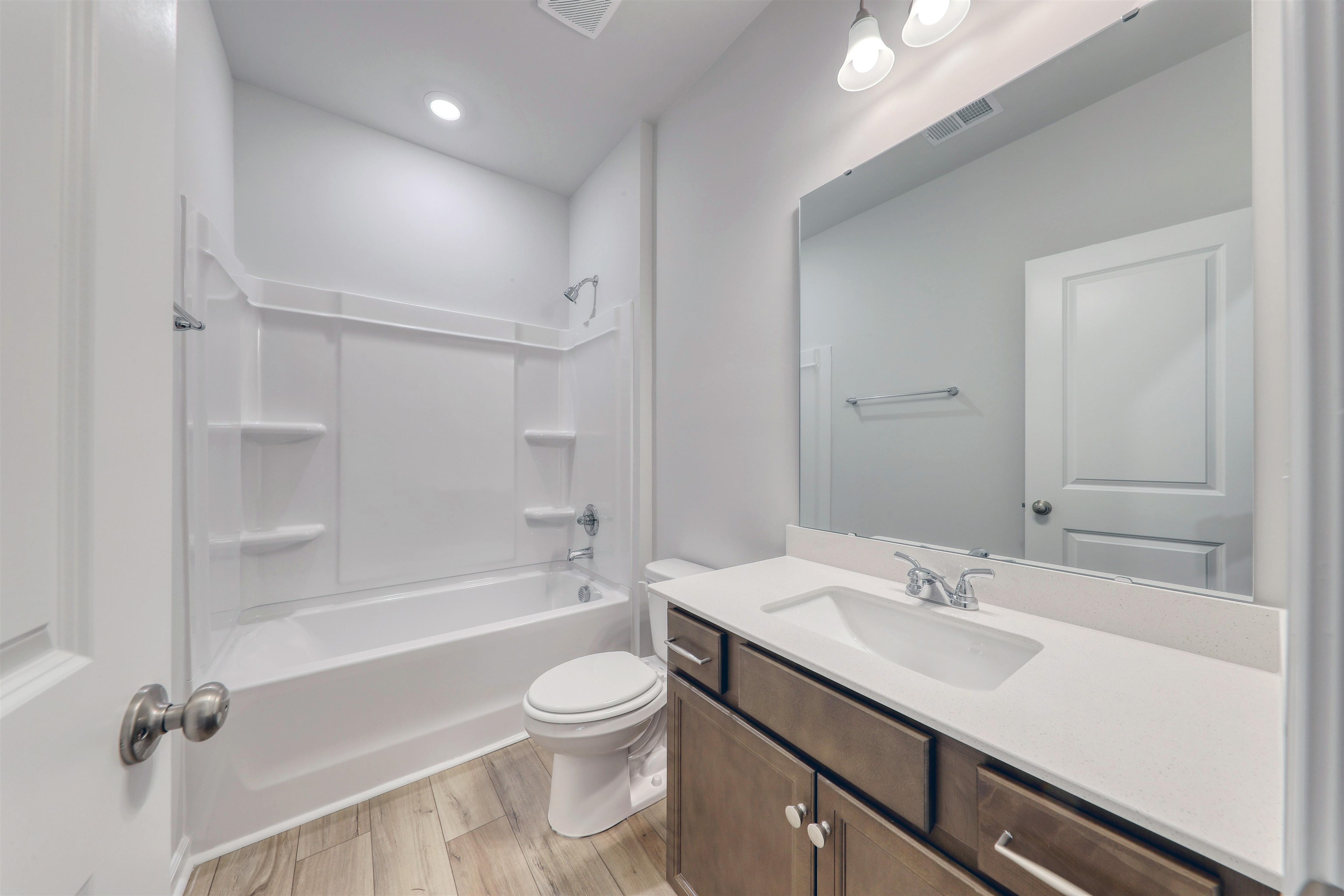 3431 Logan Street Conway, SC 29526 - Photo 5 of 31 Bathroom with vanity, bathtub / shower combination, and light wood-type flooring