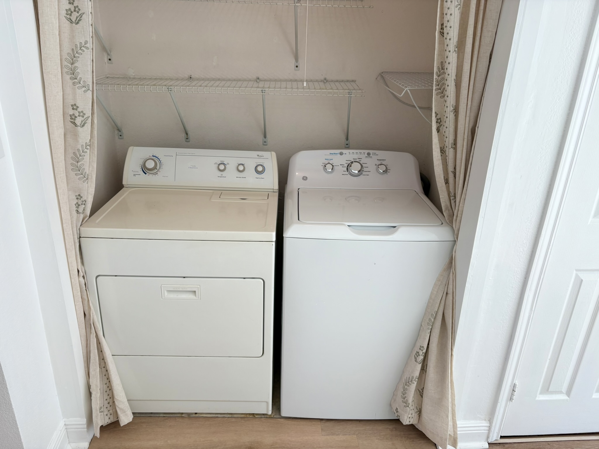 Undisclosed Address Austin, TX 78721 - Photo 15 of 28 Functional utility space includes built-in wire shelving above the laundry appliances.