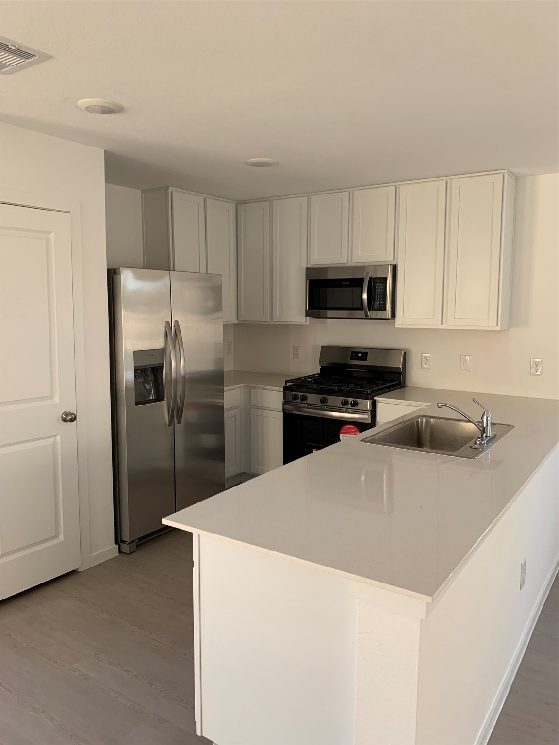 21310 Offida Lane New Caney, TX 77357 - Photo 1 of 24 a kitchen with stainless steel appliances a refrigerator sink and microwave
