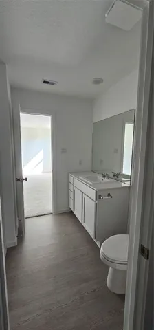a bathroom with a toilet a sink and a vanity