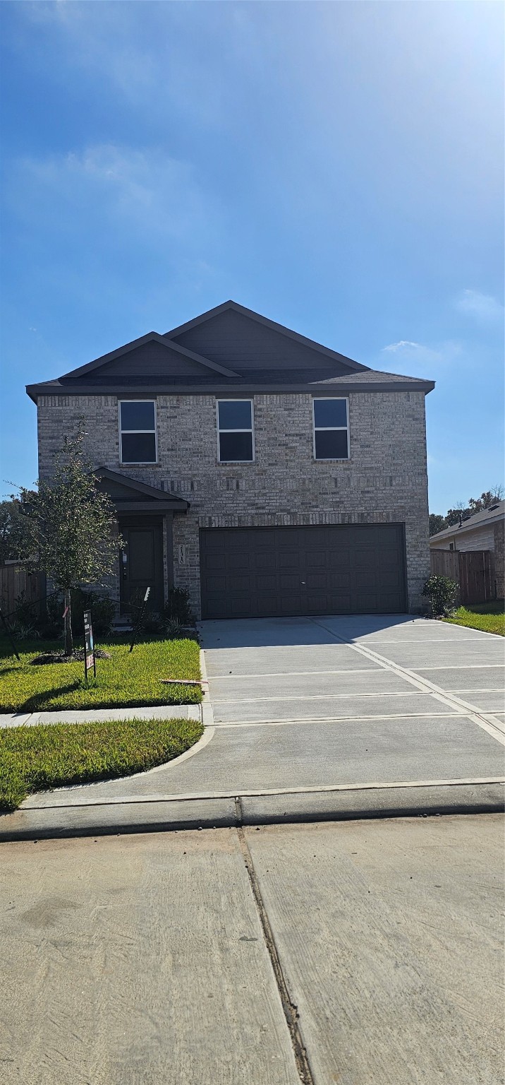 21310 Offida Lane New Caney, TX 77357 - Photo 22 of 24 a front view of a house with a yard