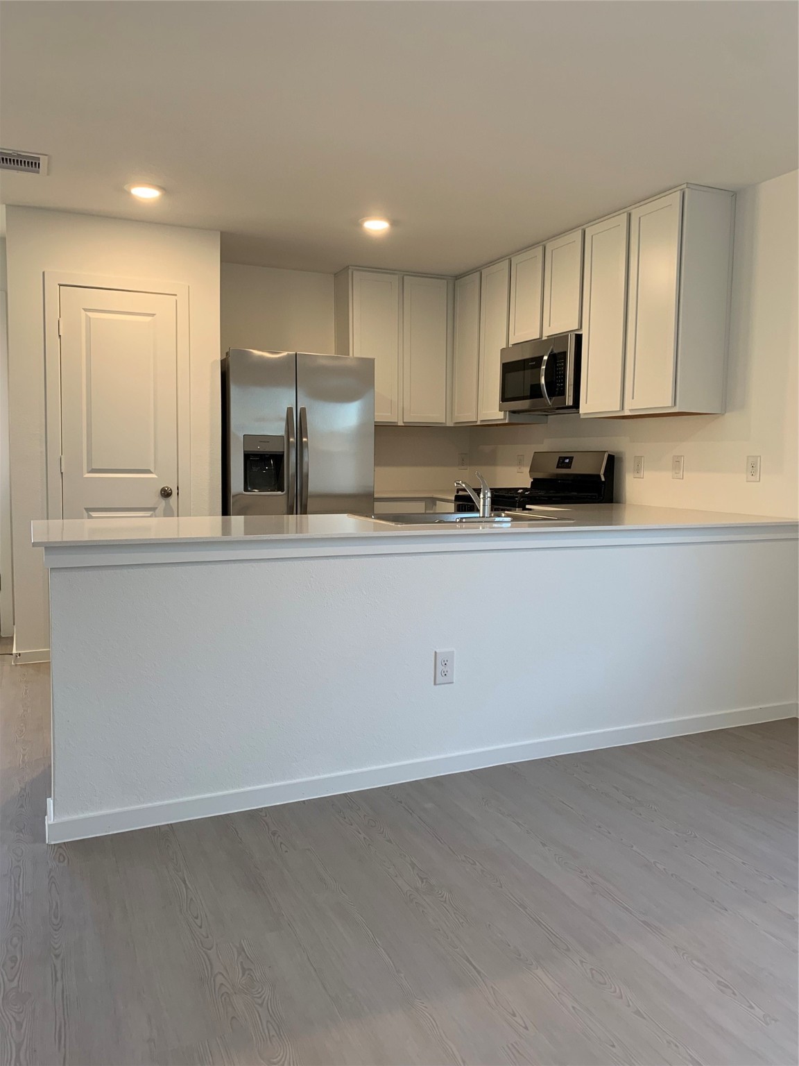 21310 Offida Lane New Caney, TX 77357 - Photo 3 of 24 a kitchen with stainless steel appliances granite countertop a stove a sink and a refrigerator