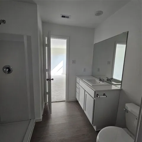 a bathroom with a granite countertop toilet sink and shower
