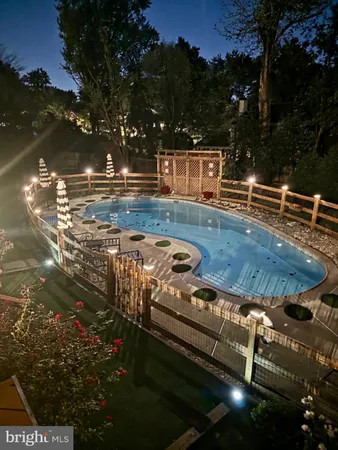 a view of a swimming pool with a yard