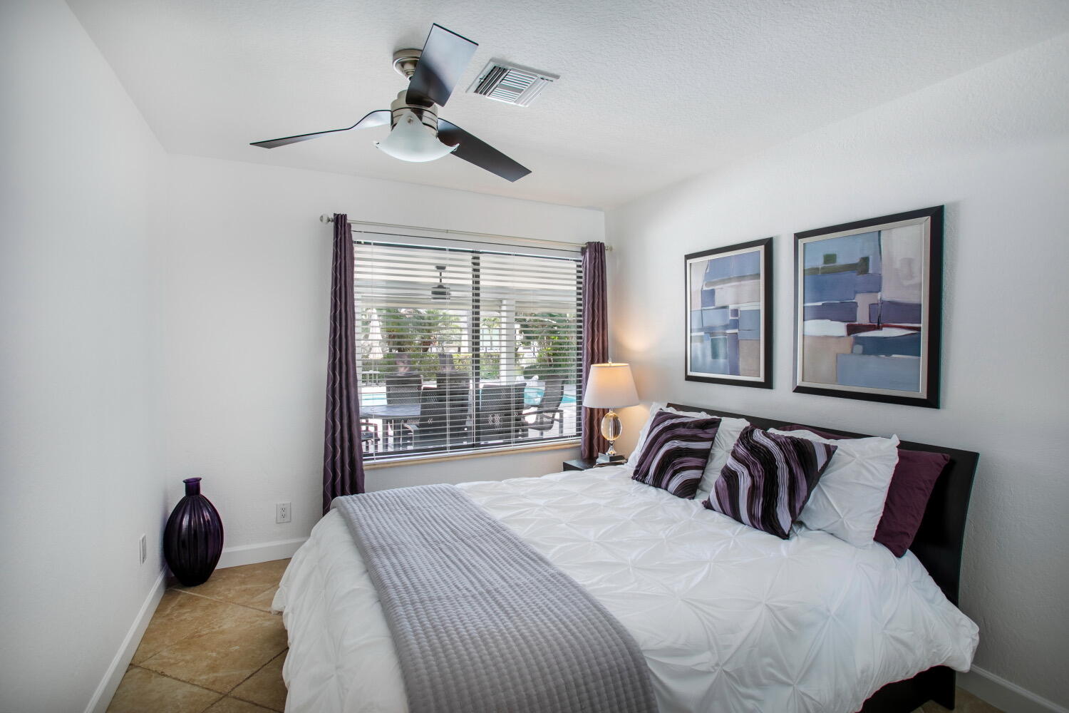 2631 Northeast 48th Street Lighthouse Point, FL 33064 - Photo 11 of 26 a bedroom with a large bed and a large window
