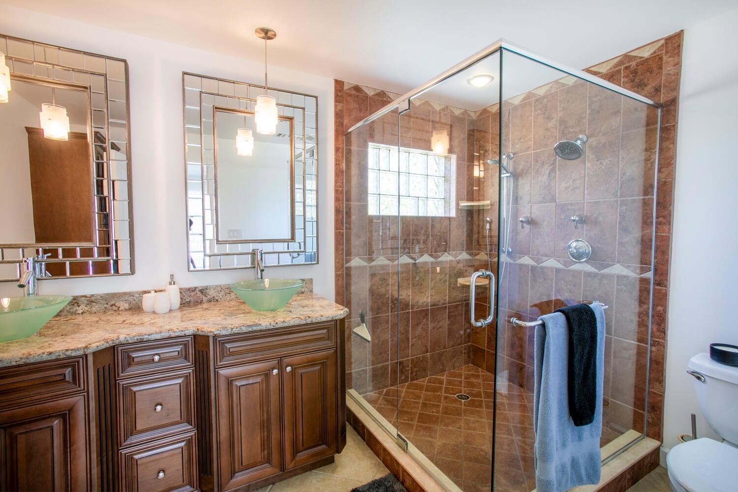 2631 Northeast 48th Street Lighthouse Point, FL 33064 - Photo 12 of 26 a bathroom with a granite countertop sink a mirror a glass door and shower