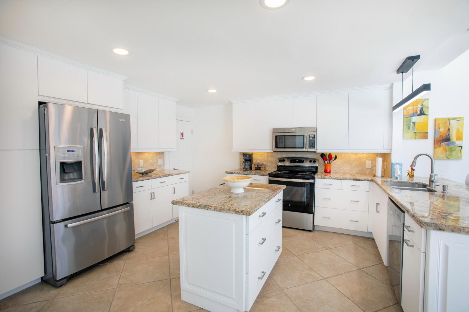 2631 Northeast 48th Street Lighthouse Point, FL 33064 - Photo 17 of 26 a kitchen with granite countertop stainless steel appliances and refrigerator