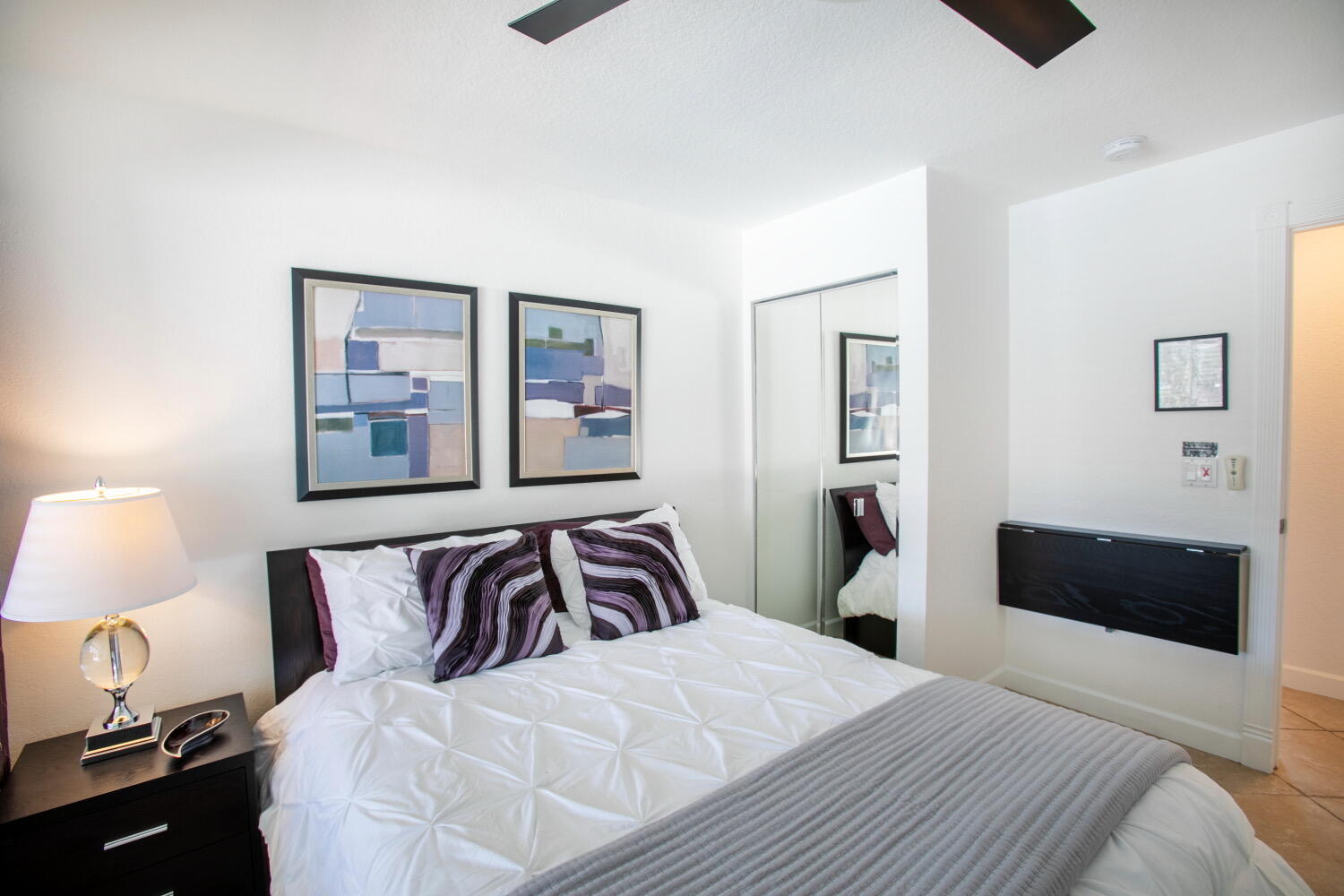 2631 Northeast 48th Street Lighthouse Point, FL 33064 - Photo 26 of 26 a bedroom with a bed and a lamp