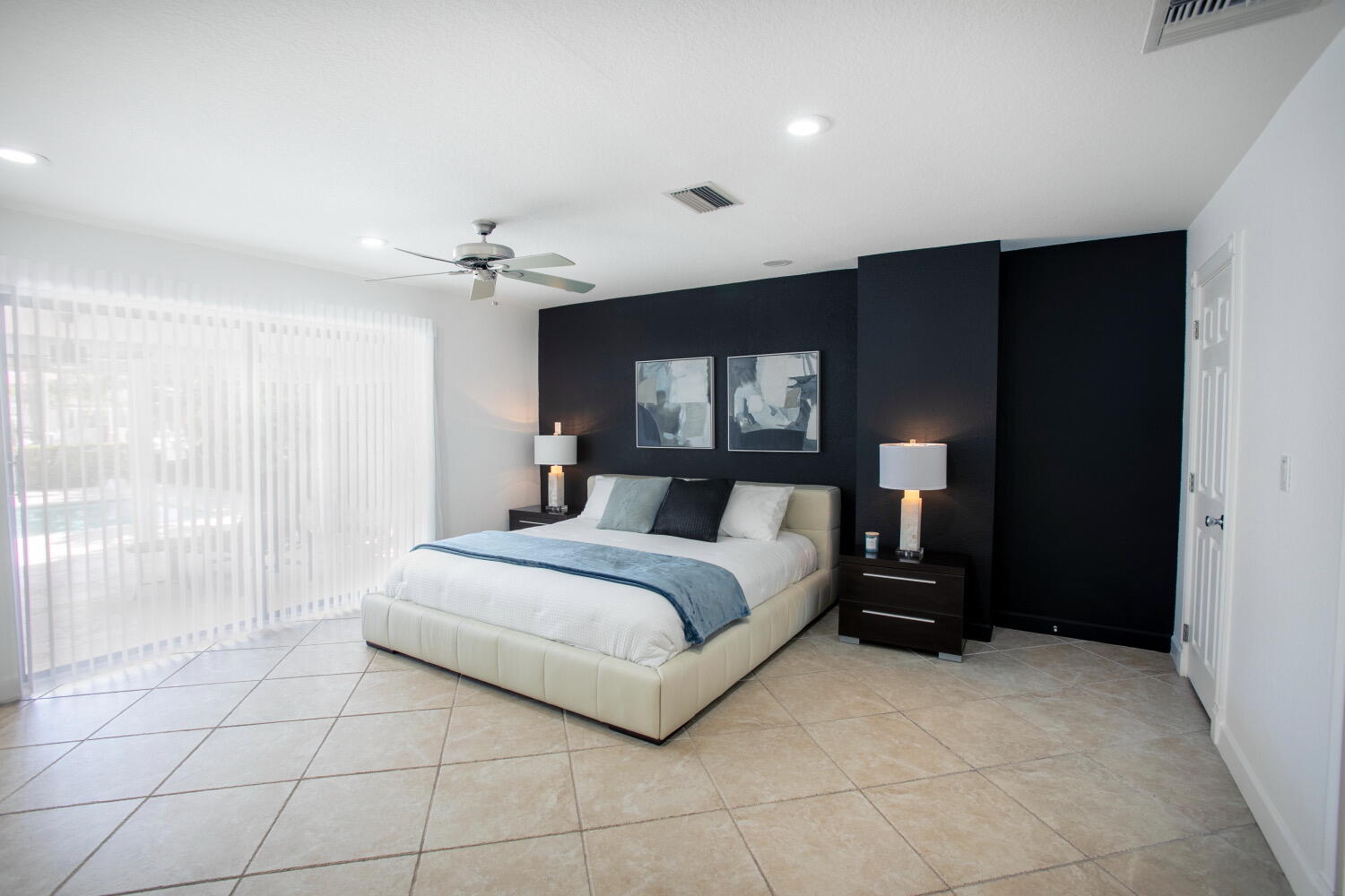 2631 Northeast 48th Street Lighthouse Point, FL 33064 - Photo 9 of 26 a spacious bedroom with a bed and a mirror