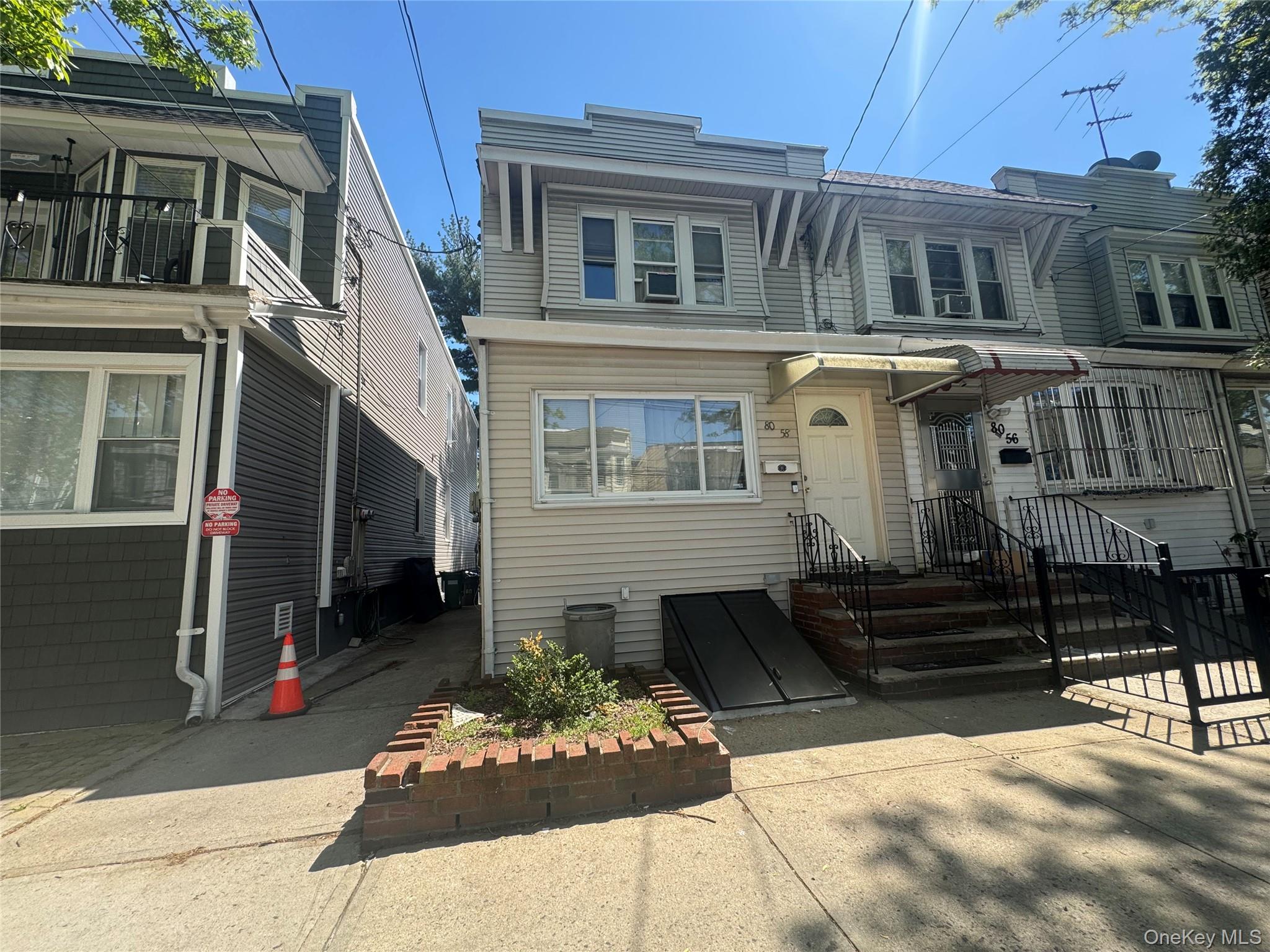 80-58 88th Road Queens, NY 11421 - Photo 1 of 21 a front view of a house with a yard