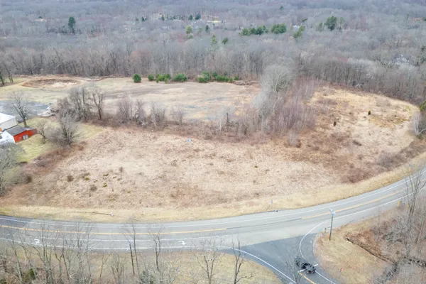a view of a dry yard with wooden fence