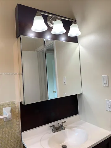 a kitchen with granite countertop a sink and a refrigerator