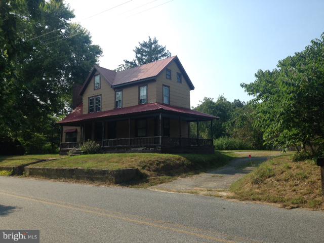 8321 Newark Road Newark, MD 21841 - Photo 2 of 33 a front view of a house with a yard and garage