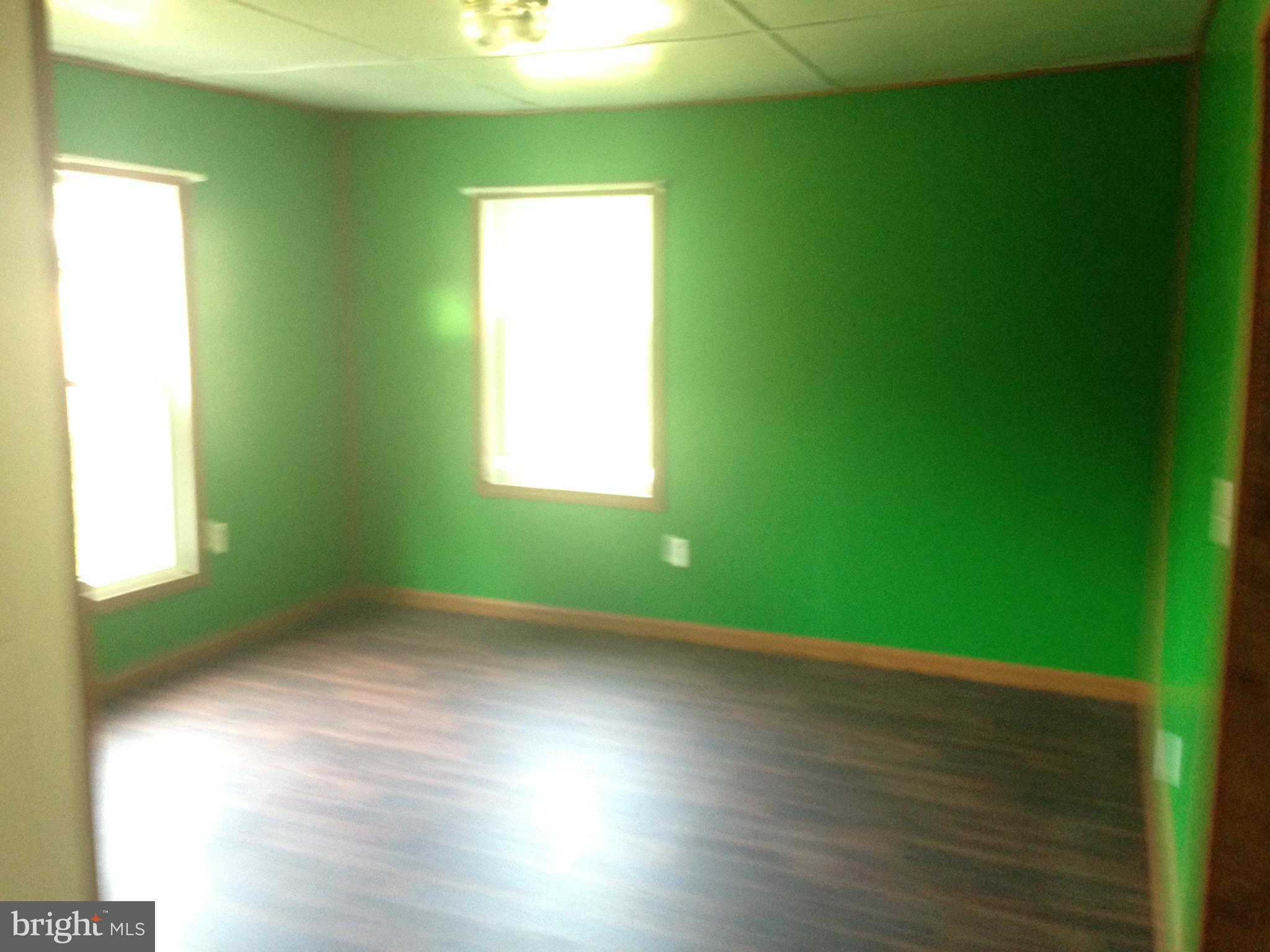 8321 Newark Road Newark, MD 21841 - Photo 21 of 33 a view of an empty room with wooden floor and a window