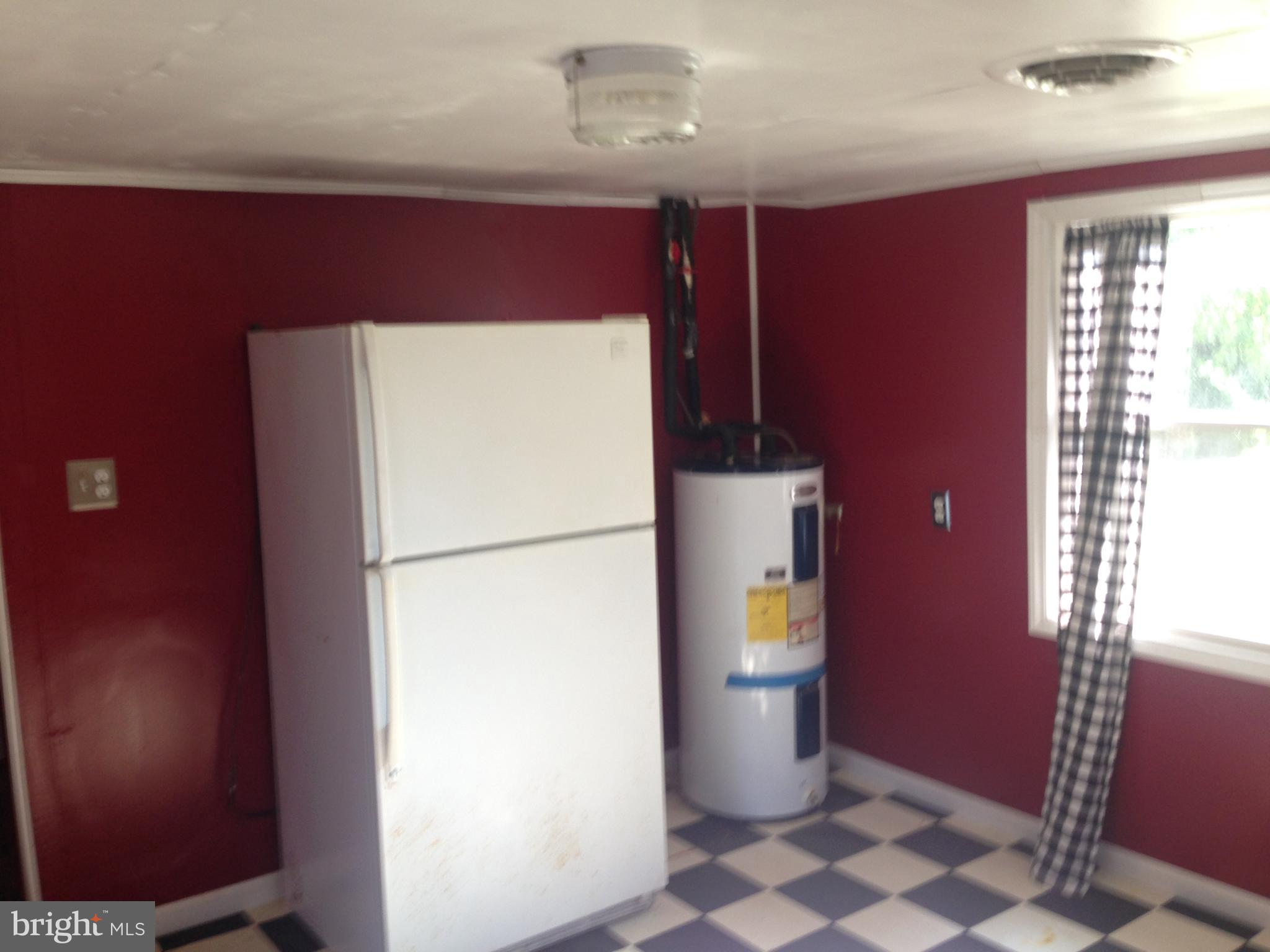 8321 Newark Road Newark, MD 21841 - Photo 6 of 33 a white refrigerator freezer and a stove sitting inside of a kitchen
