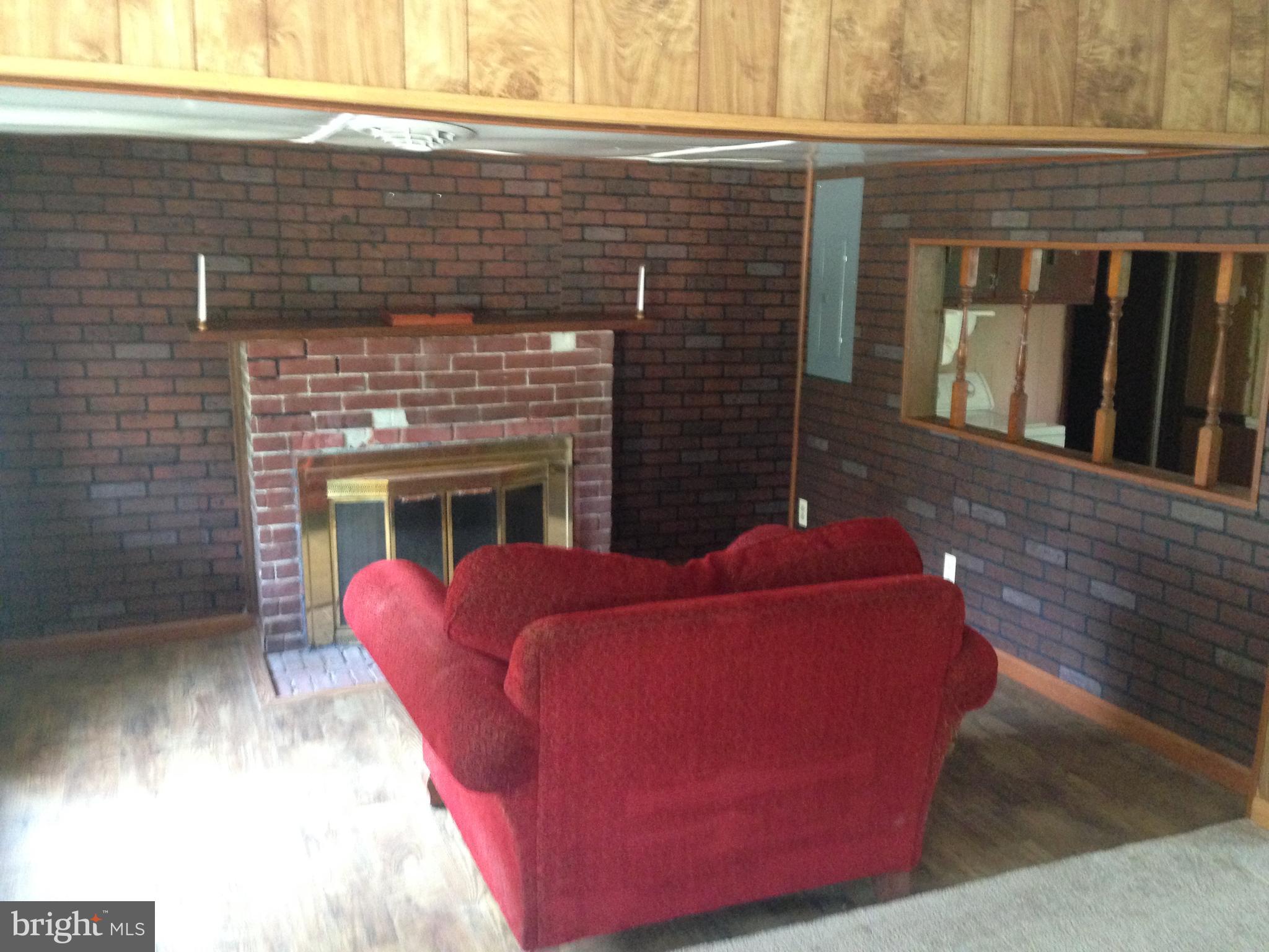 8321 Newark Road Newark, MD 21841 - Photo 7 of 33 a living room with furniture and a fireplace