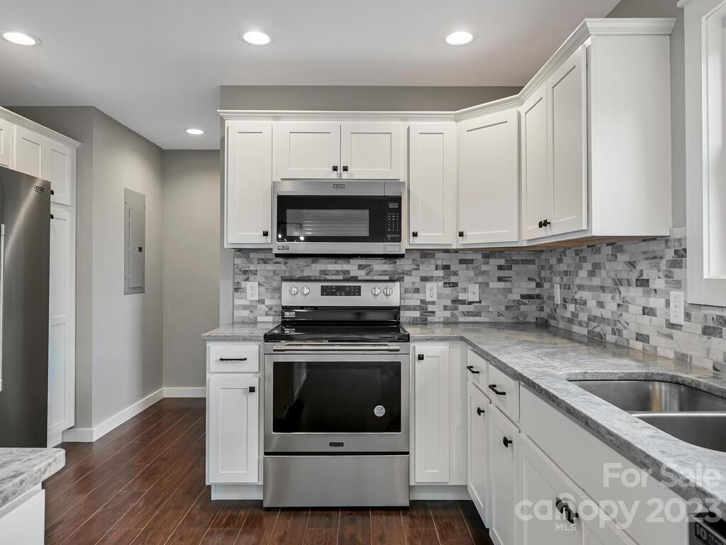 921 Newfound Road Leicester, NC 28748 - Photo 14 of 28 a kitchen with stainless steel appliances a stove a sink and a microwave