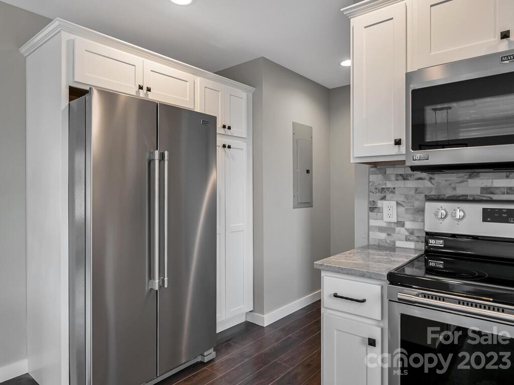 921 Newfound Road Leicester, NC 28748 - Photo 15 of 28 a kitchen with stainless steel appliances a refrigerator stove and microwave